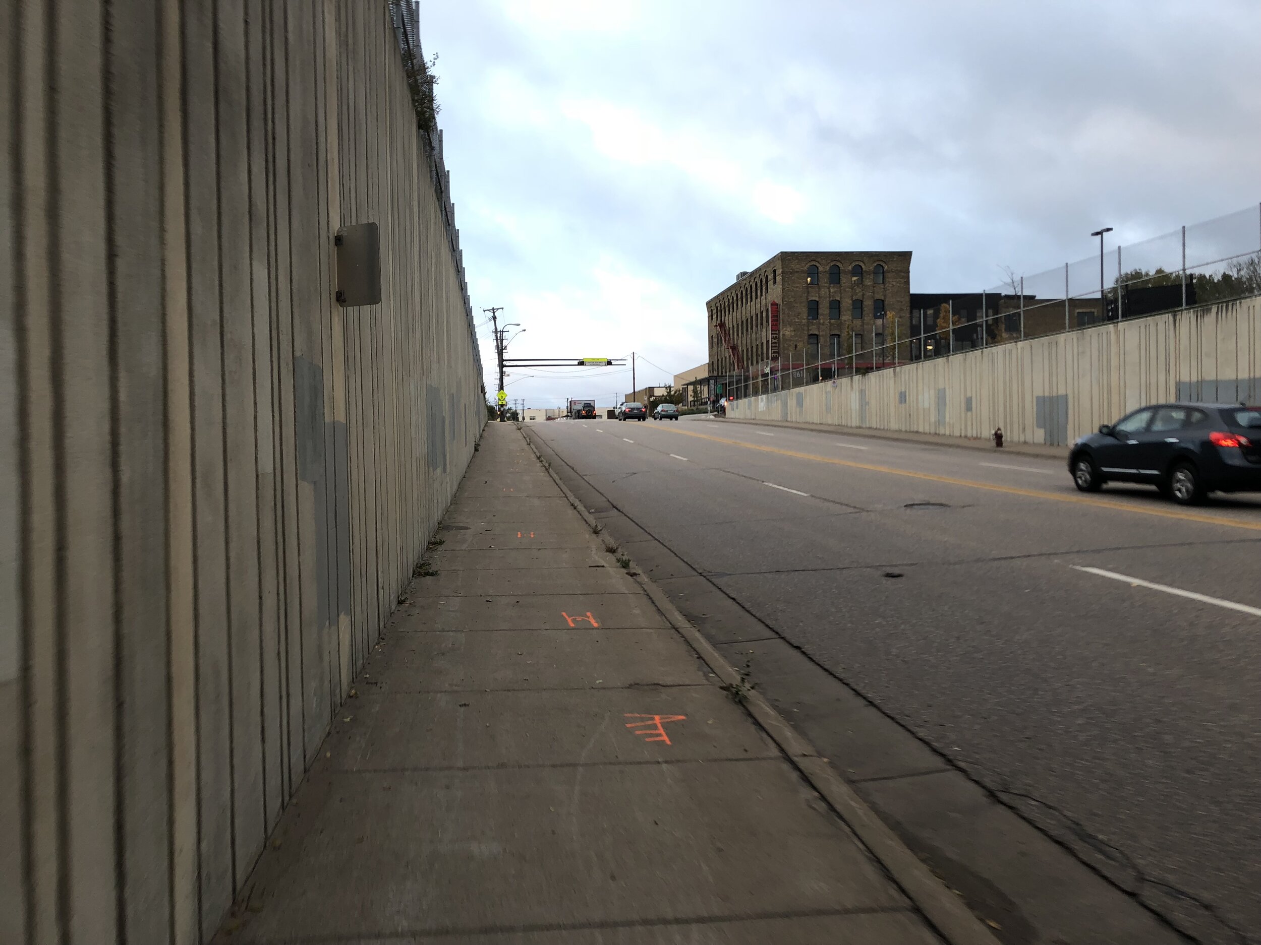A very uncomfortable sidewalk on East Hennepin Avenue in Minneapolis, far too narrow to keep a six foot separation