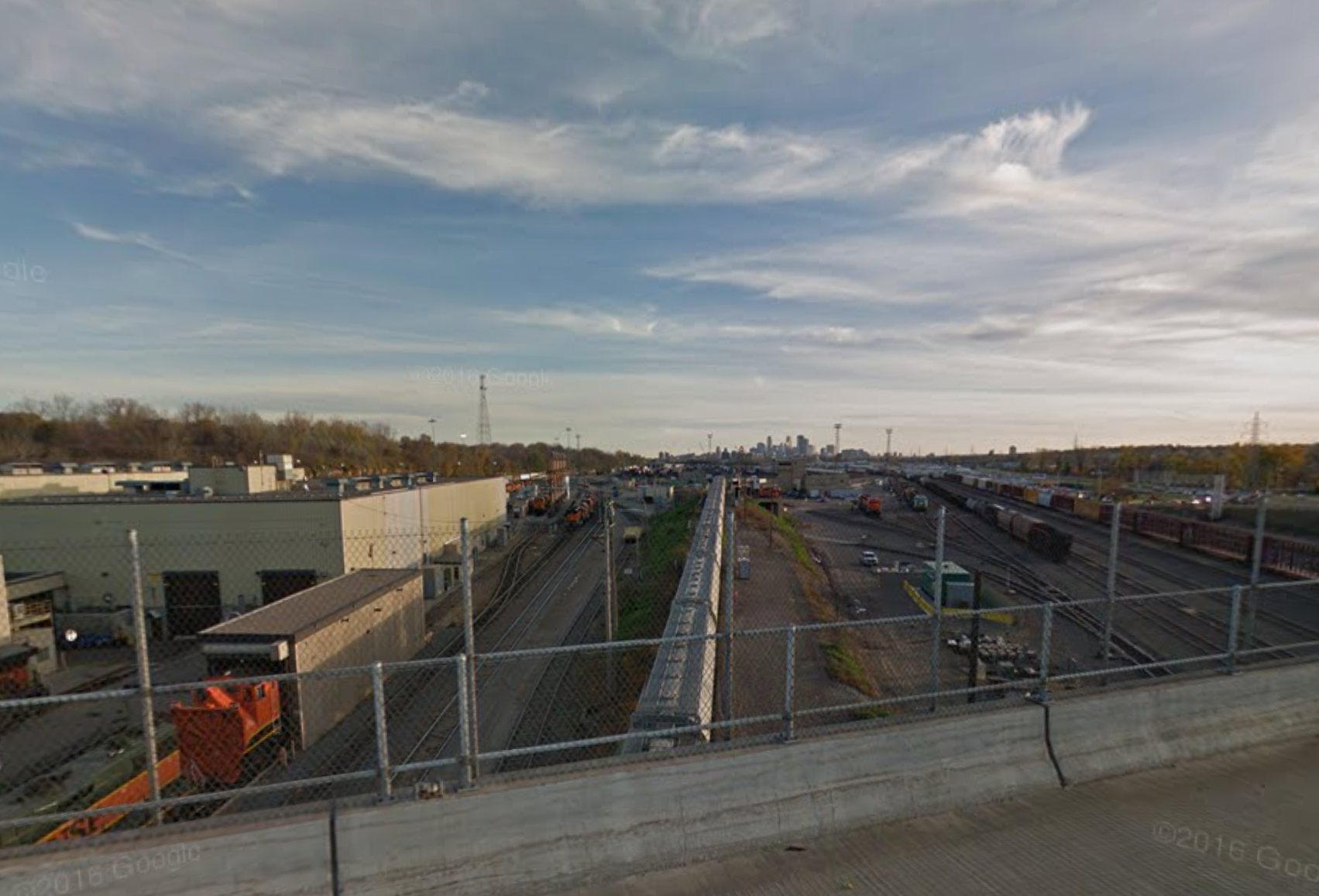 View looking south at the train yards with downtown in the background. Image courtesy of Google Street View